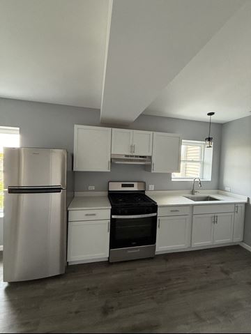 Chicago apartment for rent - A kitchen with white cabinets and stainless steel appliances.