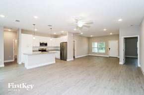 Palm Bay house for rent - A spacious kitchen with a bar area and a refrigerator.