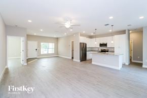Palm Bay house for rent - A spacious kitchen with a bar area and a refrigerator.