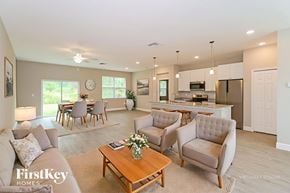 Palm Bay house for rent - A well-lit, spacious living room with a dining area and kitchen in the background.