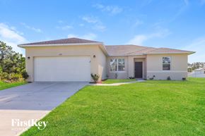 Palm Bay house for rent - A house with a garage and a driveway in front of it.