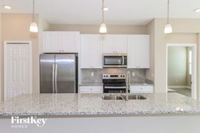 Palm Bay house for rent - A kitchen with granite countertops and stainless steel appliances.