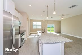 Palm Bay house for rent - A kitchen with a marble countertop and stainless steel appliances.