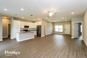 Palm Bay house for rent - A spacious kitchen with a bar area and a refrigerator.