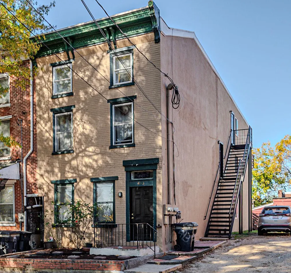 Wilmington apartment for rent - A brown building with a green door and windows.
