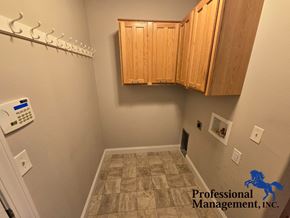 Billings house for rent - A small room with a tiled floor and wooden cabinets.
