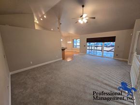 Billings house for rent - A spacious room with a carpeted floor and a ceiling fan.