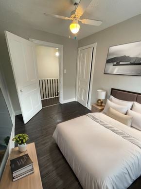 Cambridge apartment for rent - A bedroom with a bed, a nightstand, and a plant on a table.