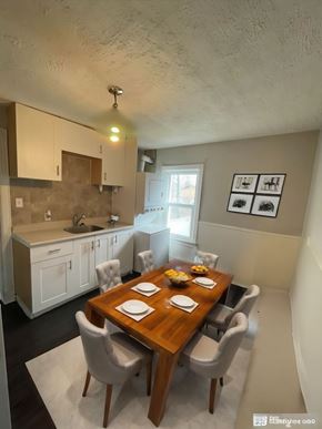 Cambridge apartment for rent - A dining room with a wooden table set for two.