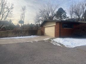 Colorado Springs house for rent - A residential area with a house and a basketball hoop.