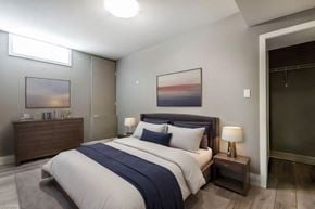 Kitchener apartment for rent - A bedroom with a large bed and a painting on the wall.
