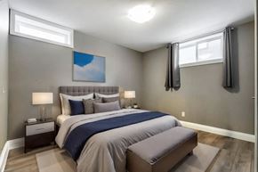 Kitchener apartment for rent - A bedroom with a large bed and a painting on the wall.
