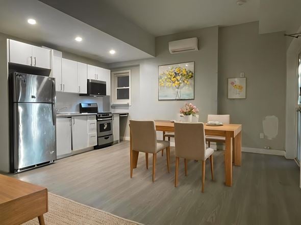 Hamilton apartment for rent - A kitchen with a table and chairs in the middle of the room.