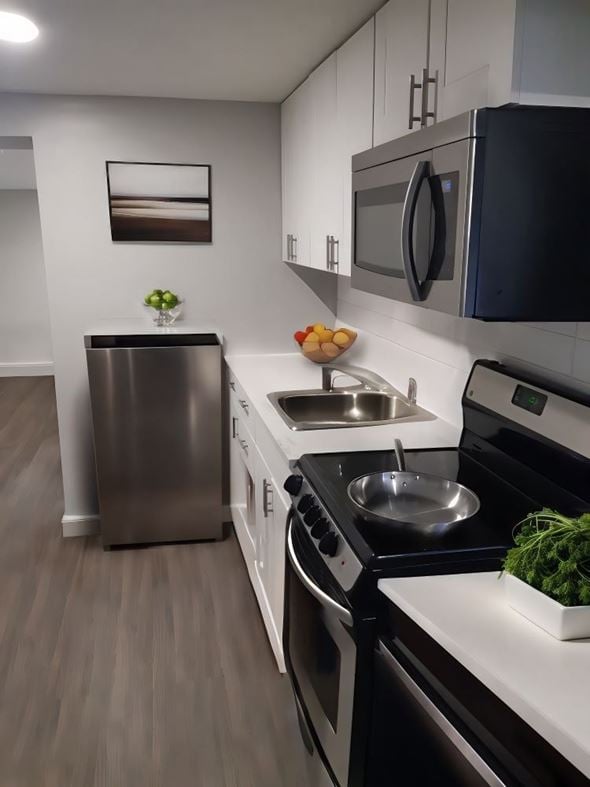 Hamilton apartment for rent - A modern kitchen with a stainless steel refrigerator, oven, and sink.