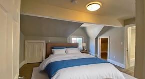 Hamilton apartment for rent - A bedroom with a bed, nightstand, and lamp.