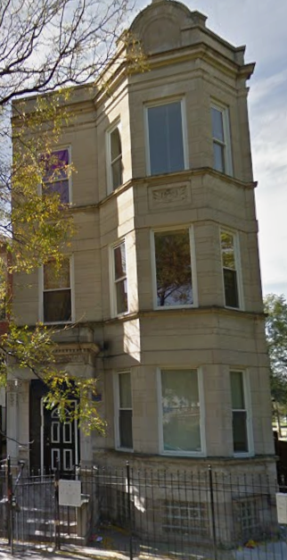 Chicago apartment for rent - A tall building with a black gate in front.