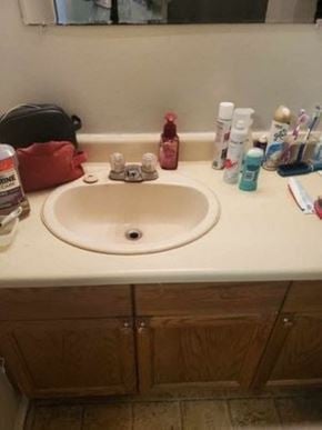 Cambridge house for rent - A bathroom sink with a red bag and various toiletries on the counter.