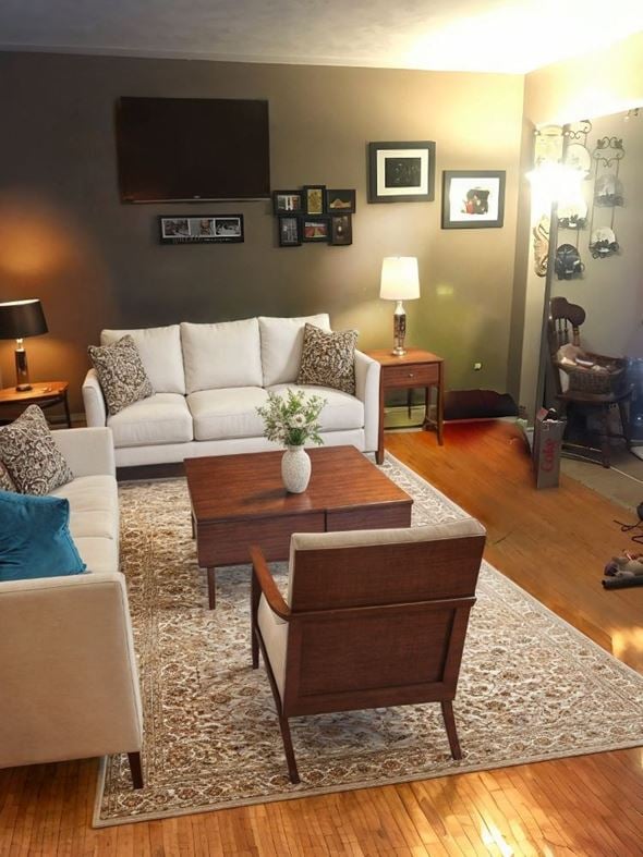 Cambridge house for rent - A living room with a white couch, a coffee table, and a rug.