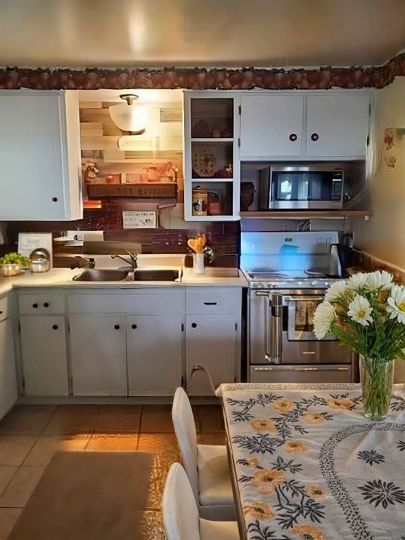 Cambridge house for rent - A kitchen with a table and chairs and a vase of flowers.