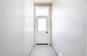 Hamilton apartment for rent - A white door is in a white hallway.