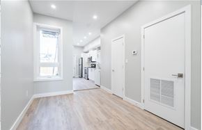 Hamilton apartment for rent - A kitchen with white cabinets and a window.