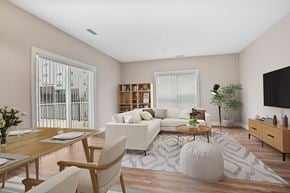 Shelton apartment for rent - A modern living room with a white sofa, wooden coffee table, and a large window with blinds.