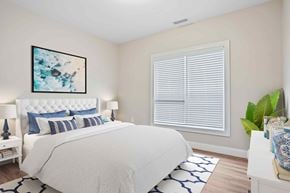 Shelton apartment for rent - A bedroom with a large bed and a painting on the wall.