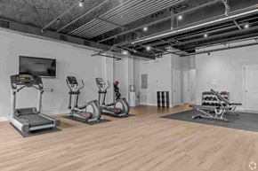 Shelton apartment for rent - A gym with treadmills, elliptical machines, and a television.