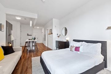 New Rochelle apartment for rent - A bedroom with a large bed and a couch.