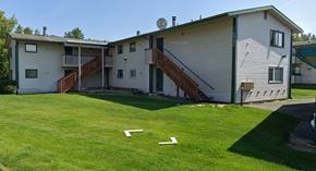 Anchorage apartment for rent - A house with a green lawn in front.