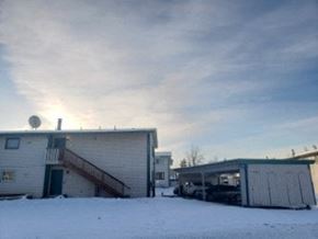 Anchorage apartment for rent - A building with a green roof is surrounded by snow.