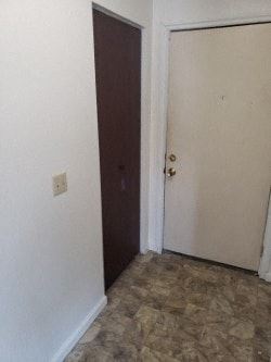 Anchorage apartment for rent - A room with a brown door and a white door.