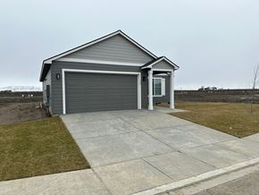 Grandview house for rent - A two-car garage with a grey roof and a white door is situated in a grassy area.