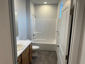 Grandview house for rent - A white bathroom with a toilet, sink, and bathtub.