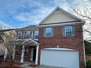 Durham house for rent - A two-story house with a garage door.