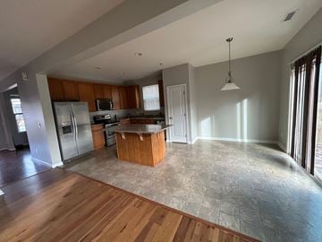Durham house for rent - A kitchen with wooden cabinets and a tiled floor.