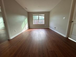 Durham house for rent - A room with wooden floors and a window.