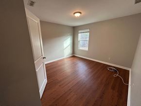 Durham house for rent - A room with wooden flooring and a window.