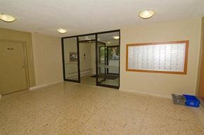 Ajax apartment for rent - A room with a calendar on the wall and a blue bin on the floor.