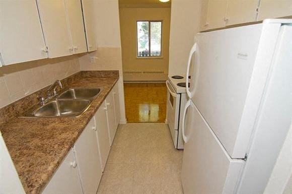 Ajax apartment for rent - A kitchen with white appliances and brown granite countertops.