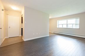 Hamilton apartment for rent - A room with a white door and a window with white curtains.