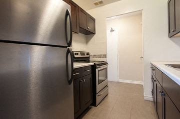 Hamilton apartment for rent - A kitchen with a stainless steel refrigerator and oven.