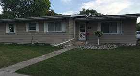 Moorhead house for rent - A beige house with a white door and windows.