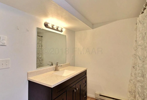 Moorhead house for rent - A bathroom with a sink and mirror.