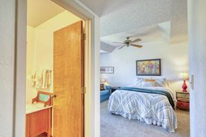 Pagosa Springs apartment for rent - A bedroom with a bed and a ceiling fan.