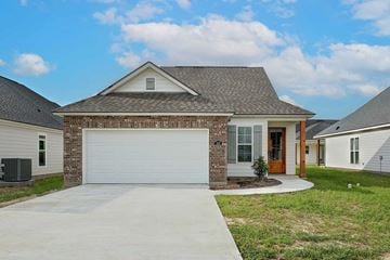 Youngsville house for rent - A house with a garage door and a brick wall.