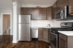 Minneapolis apartment for rent - A modern kitchen with dark wood cabinets and stainless steel appliances.
