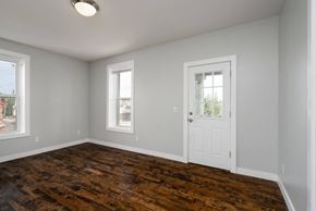 Minneapolis apartment for rent - A room with a wooden floor and white walls.