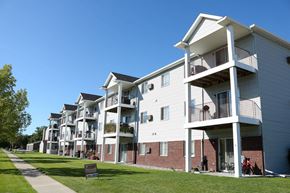 Fargo apartment for rent - a row of apartments with balconies and a sidewalk