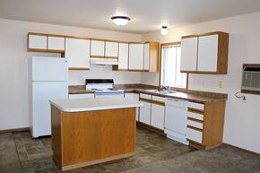 Fargo apartment for rent - an empty kitchen with white appliances and white cabinets